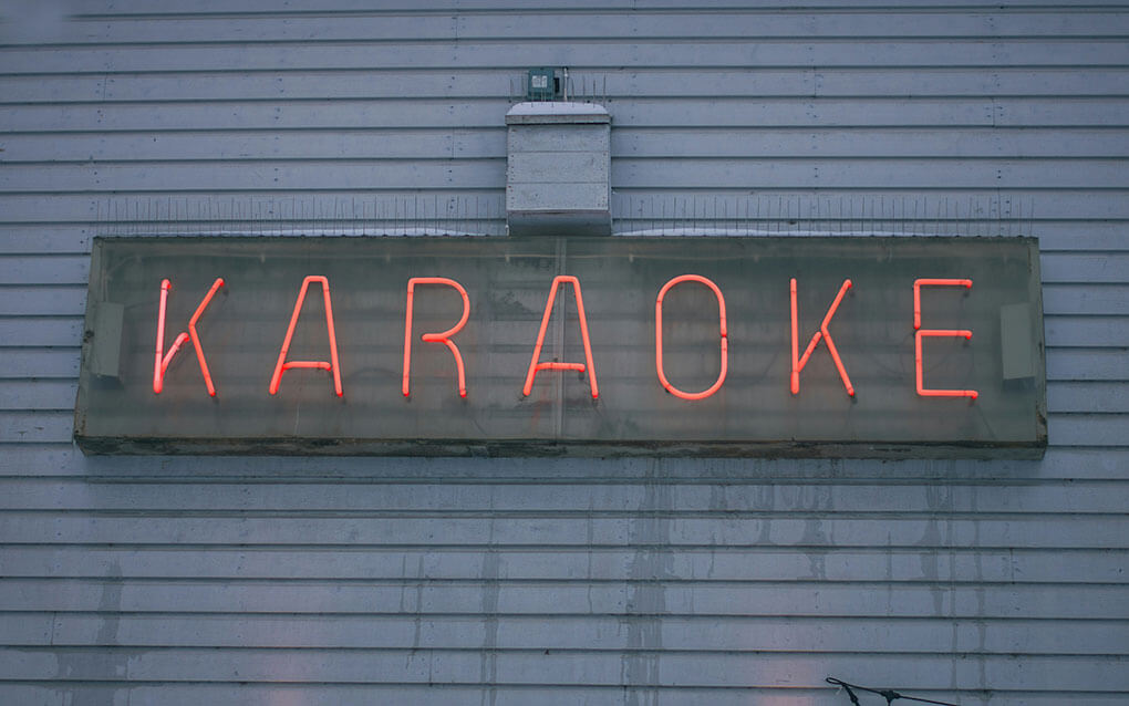 A neon red sign that says Karaoke