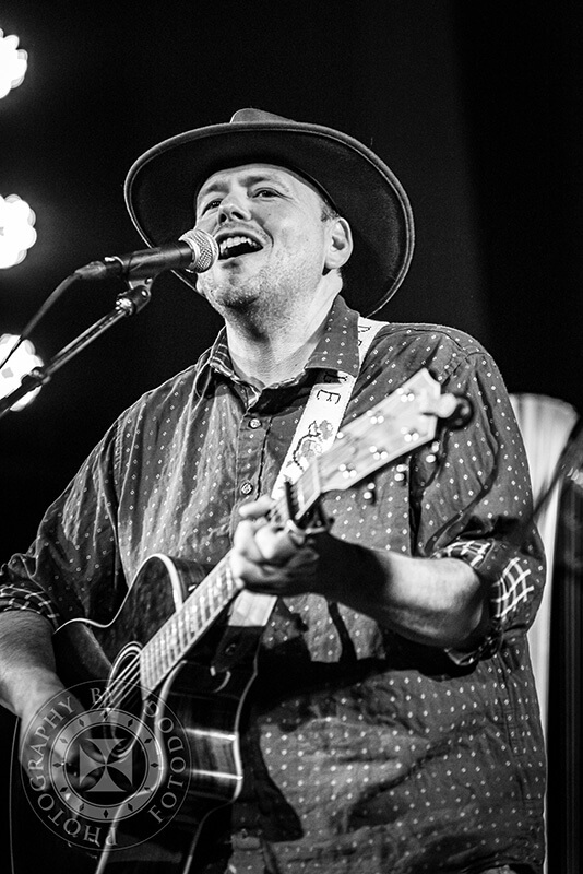 Doyle Turner on stage playing singing while playing guitar