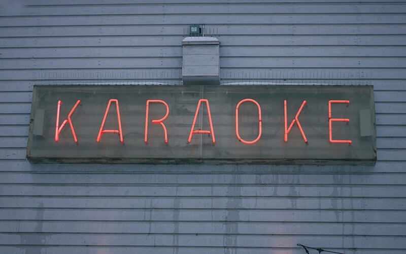 Red lettered sign that says Karaoke